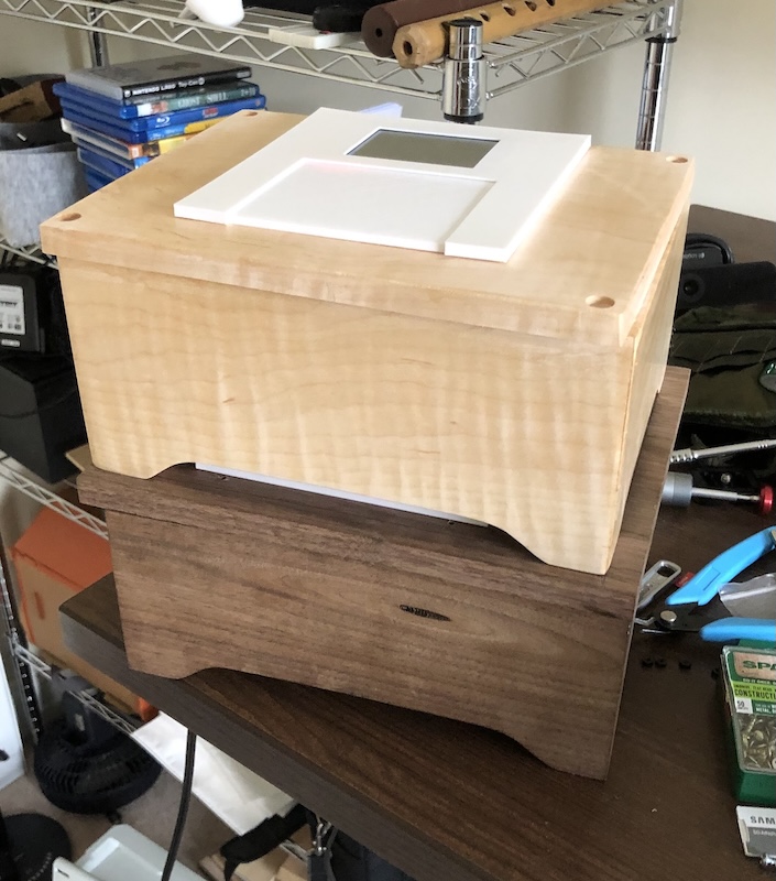 Two finished FamilySong boxes stacked, showing the wooden enclosure and touchscreen